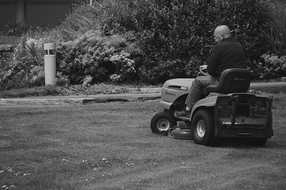 Commercial riding lawn mower cutting grass